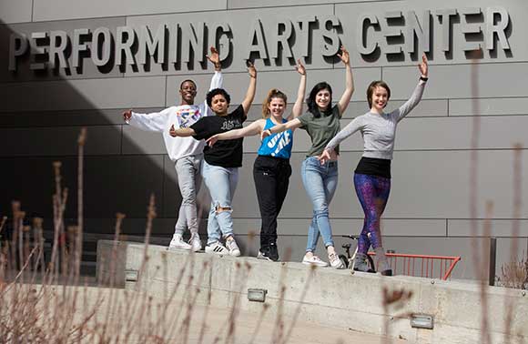 Photo of SUNY Potsdam dance students Stephon Williams, Alonicha Triana, Laura Kelly, Emma Starace and Creszenz Bergmeier outside the Performing Arts Center