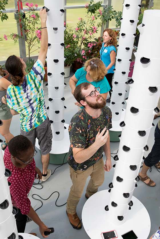 photo of student and Tower Garden in Wiser Greenhouse