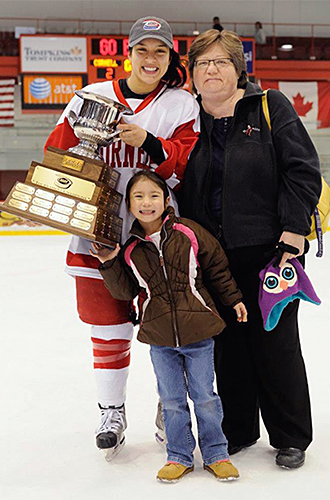olivia cook with a hockey trophy next to her mom