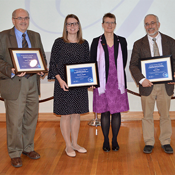 The 2019 Chancellor’s Award recipients posed after receiving their honors at SUNY Potsdam. From left, James Madeja, Sherry Paradis, President Kristin Esterberg and Joel Foisy (not pictured: Joe Timmerman).