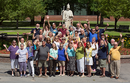 Alumni gather in front of Minerva for a photo